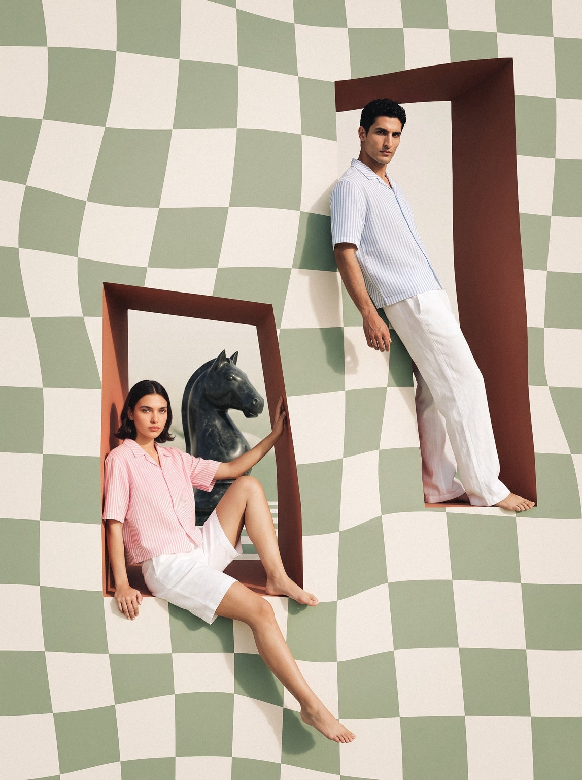 Pawn Up models framed by a warped chess wall